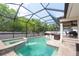 Inviting screened pool and spa area with lush landscaping and covered patio for outdoor entertaining at 2969 La Concha Dr, Clearwater, FL 33762
