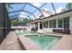 A gorgeous pool and spa are enclosed in a screened lanai with ample seating and a covered patio at 2969 La Concha Dr, Clearwater, FL 33762