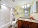 Bathroom features a sink with wood cabinets, shower, and seaside decor at 300 S Florida Ave # 600L, Tarpon Springs, FL 34689