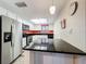 Bright kitchen with stainless steel appliances, dark countertops, and white cabinets at 300 S Florida Ave # 600L, Tarpon Springs, FL 34689