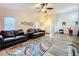 Bright living room with a ceiling fan, wood-look floors, and comfortable leather couches at 300 S Florida Ave # 600L, Tarpon Springs, FL 34689