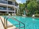 Refreshing community pool with plenty of lounge chairs and manicured landscaping at 300 S Florida Ave # 600L, Tarpon Springs, FL 34689