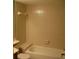 Bathroom featuring neutral colored tiles, a bathtub with shower, and updated fixtures at 3077 Casa Del Sol Cir # 207, Clearwater, FL 33761