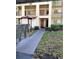 Exterior view of the building entrance featuring mailboxes and landscaping at 3077 Casa Del Sol Cir # 207, Clearwater, FL 33761