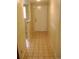 Hallway view featuring tile floors and a white entry door to the home at 3077 Casa Del Sol Cir # 207, Clearwater, FL 33761