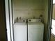 Functional laundry room with washer, dryer, and storage shelves at 3077 Casa Del Sol Cir # 207, Clearwater, FL 33761