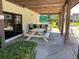 Covered patio area with picnic tables and bar seating, located near the pool, for outdoor dining and entertainment at 3077 Casa Del Sol Cir # 207, Clearwater, FL 33761