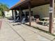 Covered patio area with lounge chairs, picnic tables, and bar seating, ideal for outdoor gatherings and relaxation at 3077 Casa Del Sol Cir # 207, Clearwater, FL 33761