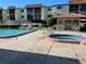 Community pool and spa with a gazebo, surrounded by well-maintained landscaping and multi-story residential buildings at 3077 Casa Del Sol Cir # 207, Clearwater, FL 33761