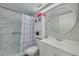 Bathroom featuring flamingo-themed shower curtain, white vanity, and round mirror above the sink at 3114 Lake Pine Way # G1, Tarpon Springs, FL 34688