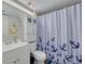Cozy bathroom with a toilet, vanity, and anchor-themed shower curtain at 3114 Lake Pine Way # G1, Tarpon Springs, FL 34688