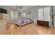 Bright bedroom with wood floors, white furniture, and lots of natural light at 3114 Lake Pine Way # G1, Tarpon Springs, FL 34688