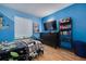 Bright bedroom with blue walls, modern furniture, and a window providing natural light at 3114 Lake Pine Way # G1, Tarpon Springs, FL 34688