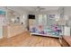 Comfortable bedroom features natural light, wood flooring, and a light wood dresser and armoire at 3114 Lake Pine Way # G1, Tarpon Springs, FL 34688