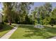 Exterior shot of community picnic area with mature trees and lawn at 3114 Lake Pine Way # G1, Tarpon Springs, FL 34688