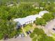 Aerial view of condos with parking in a wooded area, offering a serene environment at 3114 Lake Pine Way # G1, Tarpon Springs, FL 34688