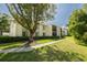 Beautiful condo building with lush green landscaping and mature shade trees at 3114 Lake Pine Way # G1, Tarpon Springs, FL 34688