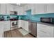 Efficient kitchen with white cabinets, stainless steel appliances, and a modern design at 3114 Lake Pine Way # G1, Tarpon Springs, FL 34688