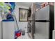 Efficient laundry room with stacked washer/dryer, mini fridge, shelving, and storage solutions at 3114 Lake Pine Way # G1, Tarpon Springs, FL 34688