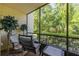 Relaxing screened patio with comfortable seating and lush green view at 3114 Lake Pine Way # G1, Tarpon Springs, FL 34688