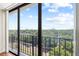 Balcony view featuring city skyline, scenic views, blue sky, and secure black metal railing at 3211 W Swann Avenue # 707, Tampa, FL 33609
