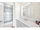 Bathroom features a glass-enclosed shower, large mirror, and white cabinets at 3211 W Swann Avenue # 707, Tampa, FL 33609