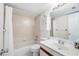 Bathroom featuring white tile, vanity, and shower-tub combination at 3211 W Swann Avenue # 707, Tampa, FL 33609