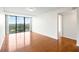 Serene bedroom featuring hardwood floors and large windows providing ample natural light and city views at 3211 W Swann Avenue # 707, Tampa, FL 33609