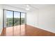 Bedroom features hardwood floors, fan, and a large window with a view at 3211 W Swann Avenue # 707, Tampa, FL 33609