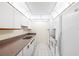 A clean kitchen features a double sink, white appliances, ample white cabinets, and a neutral countertop at 3211 W Swann Avenue # 707, Tampa, FL 33609