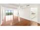 Open-concept living space with hardwood floors and large windows showcasing the beautiful outdoor scenery at 3211 W Swann Avenue # 707, Tampa, FL 33609