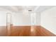Spacious living room with hardwood floors, a decorative chandelier, and an open doorway to the kitchen at 3211 W Swann Avenue # 707, Tampa, FL 33609