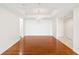 A spacious living room features a decorative chandelier, gleaming hardwood floors, and clean white walls for versatile styling at 3211 W Swann Avenue # 707, Tampa, FL 33609