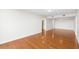A large, light-filled living room boasts pristine white walls and gleaming hardwood floors, ready for personalized touches at 3211 W Swann Avenue # 707, Tampa, FL 33609