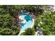 Aerial view of the community pool area, showcasing lush landscaping and comfortable lounge seating at 3211 W Swann Avenue # 707, Tampa, FL 33609