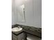 Bathroom featuring a modern sink and vanity with granite countertop and a decorative backsplash at 3221 Roxborough Ave, Clearwater, FL 33762