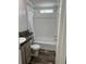 Well-lit bathroom featuring a shower-tub combo, wood-look floors, and a vanity with granite countertop at 3221 Roxborough Ave, Clearwater, FL 33762