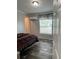 Bedroom with wood flooring, window, and air conditioner at 3221 Roxborough Ave, Clearwater, FL 33762
