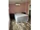 Bedroom with a bed, two bedside tables, air conditioner and wood flooring at 3221 Roxborough Ave, Clearwater, FL 33762