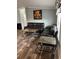 Inviting living room featuring laminate flooring, a two dark couches, and a modern coffee table at 3221 Roxborough Ave, Clearwater, FL 33762