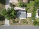 Aerial view of a home with a well-maintained roof, surrounded by greenery and paved areas at 37045 North Ave, Dade City, FL 33523