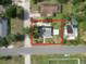Aerial view of the property showcasing the home, driveway, and surrounding greenery at 37045 North Ave, Dade City, FL 33523