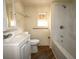 Well-lit bathroom featuring a vanity, toilet, bathtub, and modern fixtures at 37045 North Ave, Dade City, FL 33523