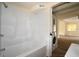 Bathroom with a tub/shower combo, and adjacent laundry area with stacked appliances at 37045 North Ave, Dade City, FL 33523