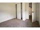 Bedroom featuring a closet with sliding doors and white trim throughout at 37045 North Ave, Dade City, FL 33523