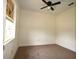 Bedroom featuring a ceiling fan, window, and neutral color palette at 37045 North Ave, Dade City, FL 33523