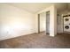 Bedroom featuring mirrored closet, neutral tones, and adjacent laundry area at 37045 North Ave, Dade City, FL 33523