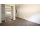 Bedroom showcasing a mirrored closet and neutral carpet with access to the hallway at 37045 North Ave, Dade City, FL 33523
