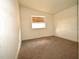 Bright bedroom with neutral tones, cozy carpet, and natural light from the window at 37045 North Ave, Dade City, FL 33523