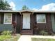 The home features a welcoming front door, nice landscaping, and shutters at 37045 North Ave, Dade City, FL 33523